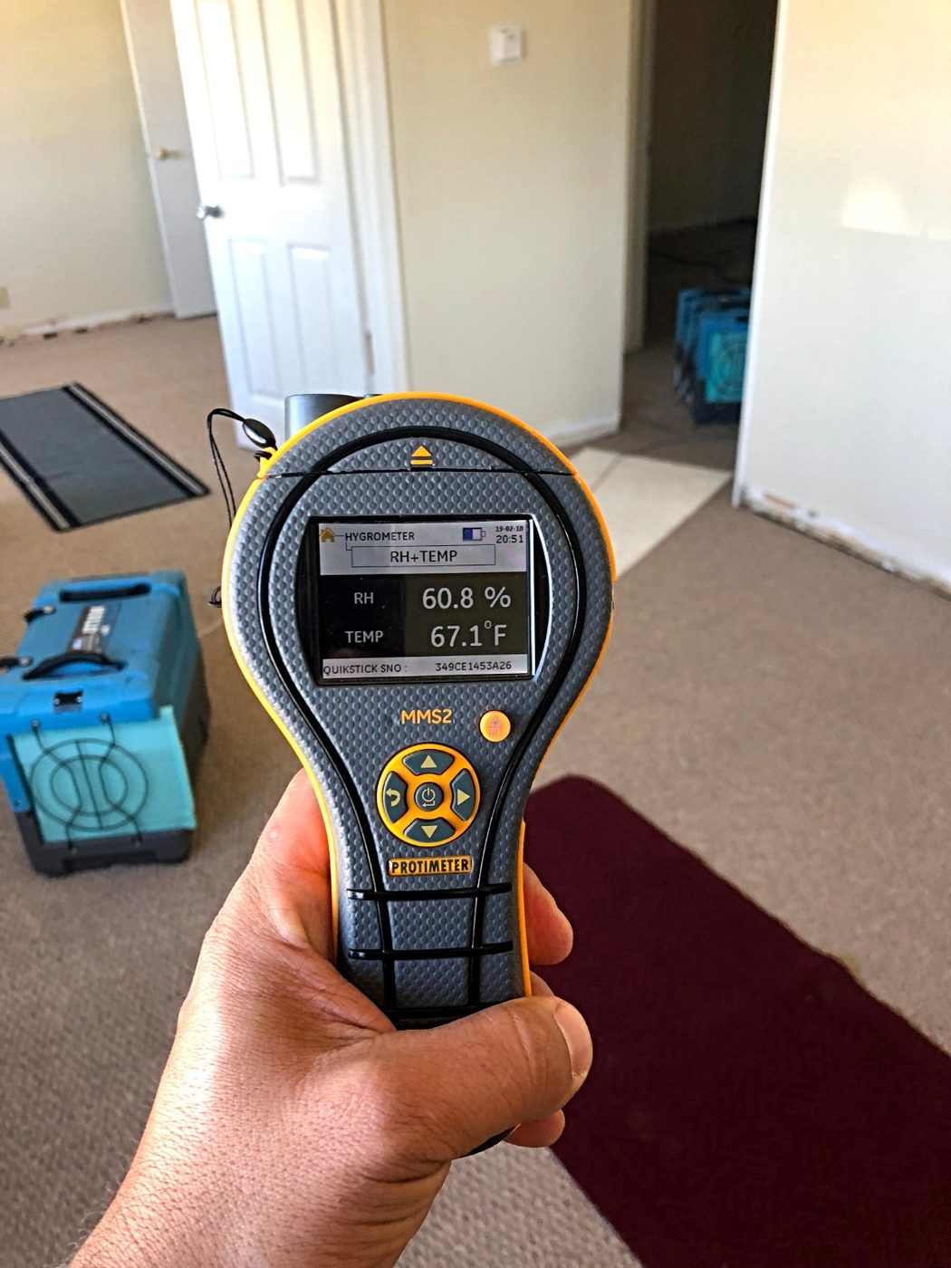 Taking a moisture reading to document an insurance claim